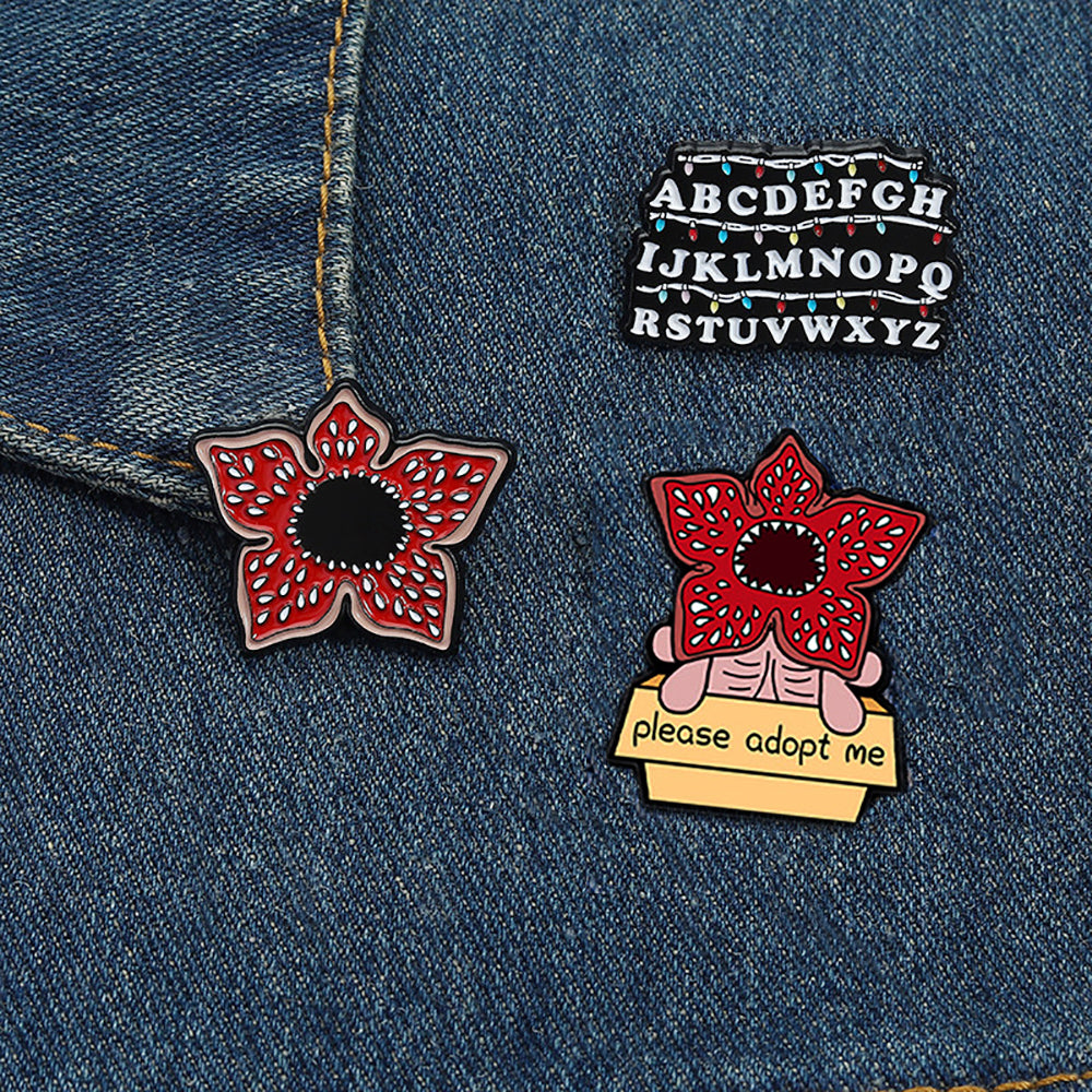 Lot de 3 pin's Stranger Things mur alphabet et Demogorgon vu de face